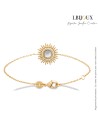 Bracelet plaqué or et nacre en forme de soleil et serti d'oxydes transparents. Longueur 18 cm anneau à 16 cm.